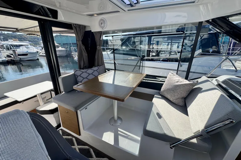 Slide: The Image of Interior of 2020 Jeanneau NC 895 boat with cozy seating and dining area. - 16