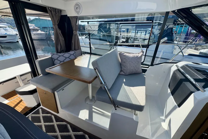 Slide: The Image of Interior of 2020 Jeanneau NC 895 boat with seating and table, docked at marina. - 17