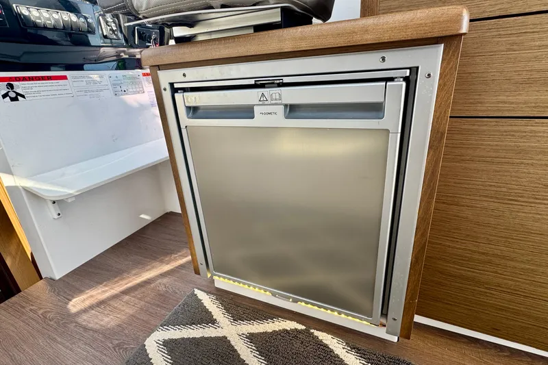 Slide: The Image of Compact kitchen area in 2020 Jeanneau NC 895 boat with built-in Dometic fridge. - 20