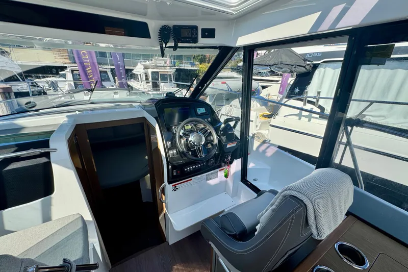 Slide: The Image of Interior view of 2020 Jeanneau NC 895 boat cockpit with steering wheel and seating. - 21