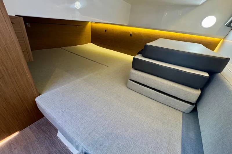 Slide: The Image of Interior cabin of 2020 Jeanneau NC 895 boat with cushions and ambient lighting. - 27