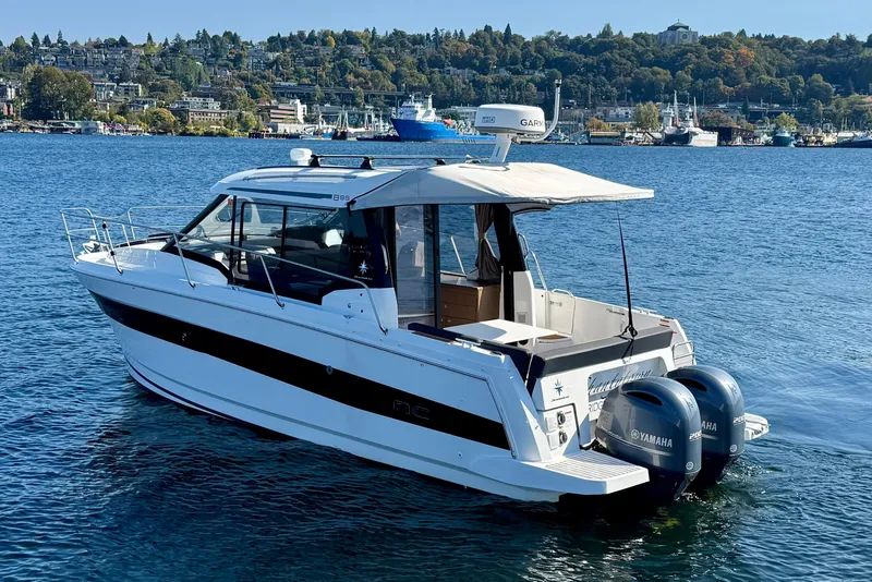 Slide: The Image of 2020 Jeanneau NC 895 boat on water with twin Yamaha engines, scenic background. - 3