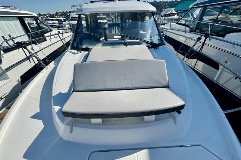 Slide: The Image of 2020 Jeanneau NC 895 boat with cushioned seating on deck, docked at marina. - 31