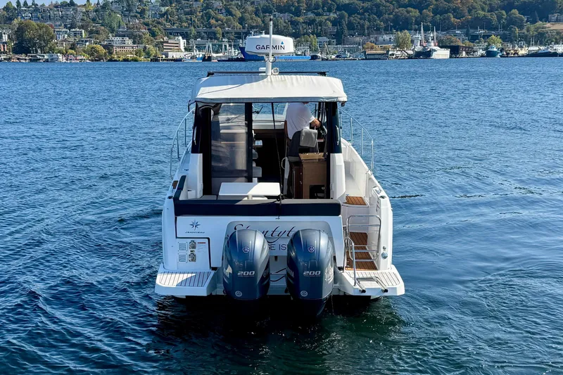 Slide: The Image of 2020 Jeanneau NC 895 boat on water with twin engines, scenic background. - 6