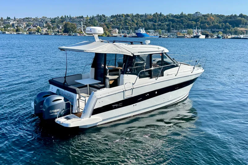 Slide: The Image of 2020 Jeanneau NC 895 boat on water, featuring Yamaha engines, scenic shoreline background. - 8