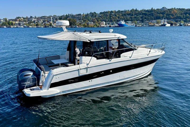 Slide: The Image of 2020 Jeanneau NC 895 boat on calm water, featuring sleek design and Yamaha engines. - 9