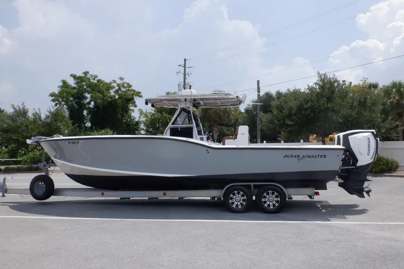 Slide: The Image of 1995 Ocean Master 31 Center Console boat on trailer, parked outdoors. - 10