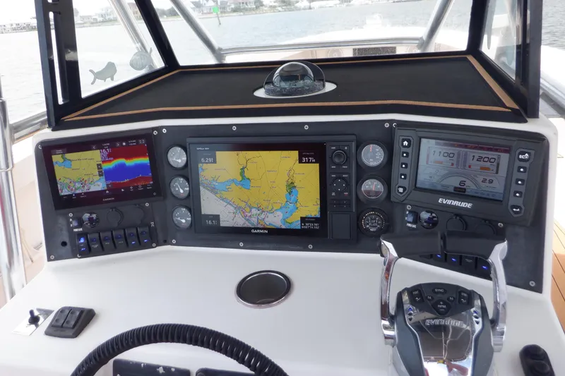 Slide: The Image of 1995 Ocean Master 31 Center Console dashboard with navigation and control systems. - 11