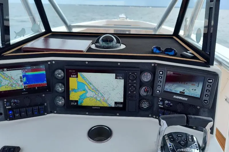 Slide: The Image of 1995 Ocean Master 31 Center Console dashboard with navigation screens and controls. - 14