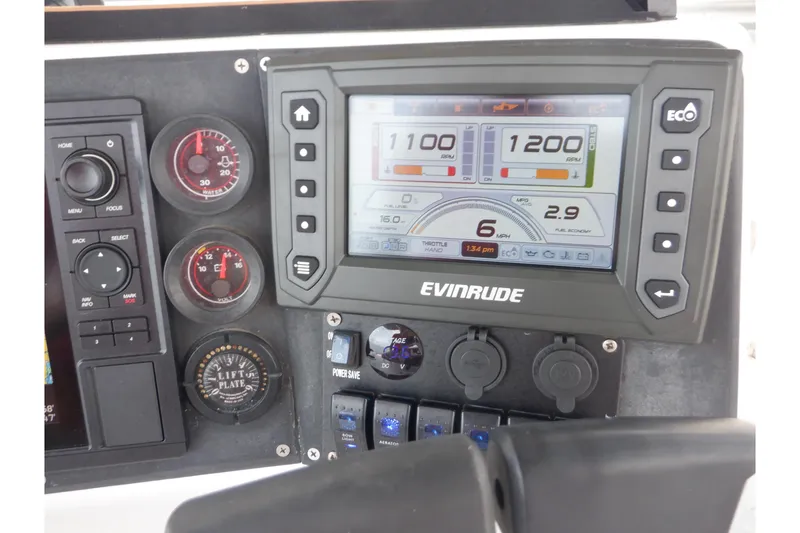 Slide: The Image of 1995 Ocean Master 31 Center Console dashboard with Evinrude display and gauges. - 19