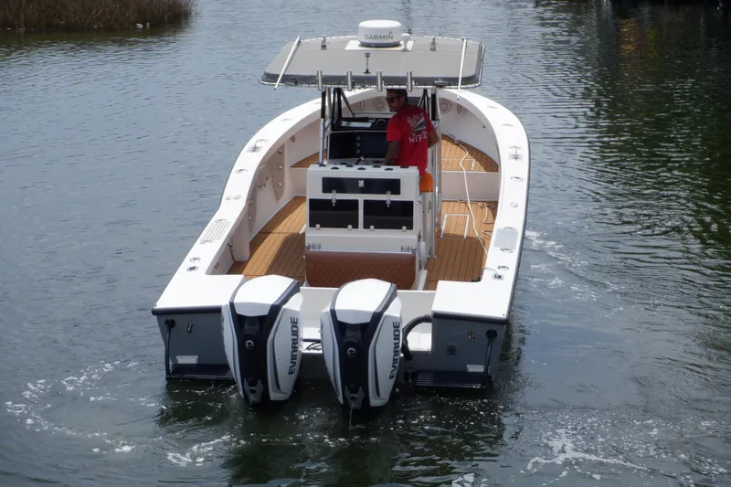 Slide: The Image of 1995 Ocean Master 31 Center Console boat with dual Evinrude engines on water. - 2