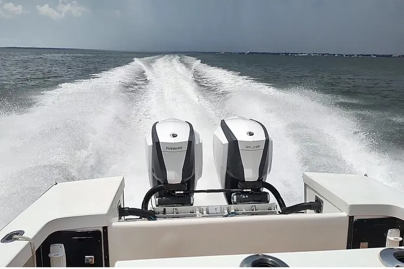 Slide: The Image of Ocean Master 31 Center Console boat, 1995 model, cruising with dual Evinrude engines. - 22