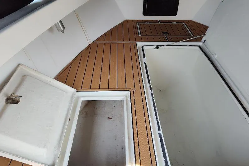 Slide: The Image of 1995 Ocean Master 31 Center Console interior with open storage compartments. - 24