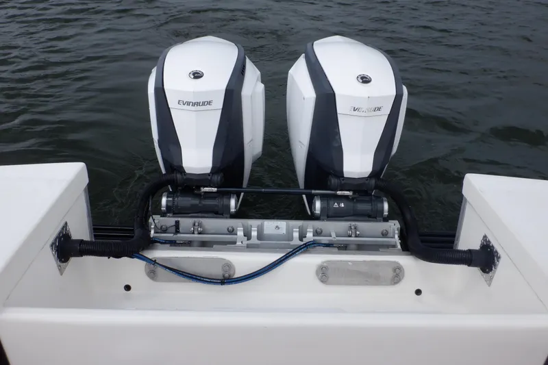 Slide: The Image of Twin Evinrude engines on a 1995 Ocean Master 31 Center Console boat. - 28