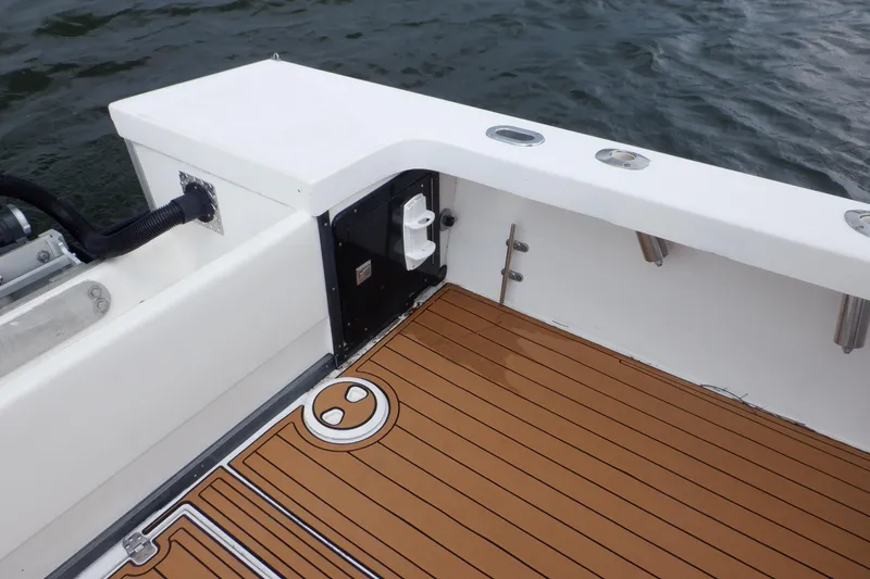 Slide: The Image of 1995 Ocean Master 31 Center Console boat deck with teak flooring and rod holders. - 31
