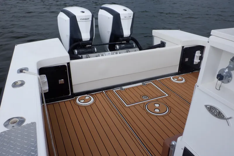 Slide: The Image of 1995 Ocean Master 31 Center Console boat with twin Evinrude engines on teak deck. - 32