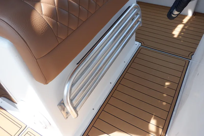 Slide: The Image of Brown leather seat and metal rail on 1995 Ocean Master 31 Center Console boat. - 33