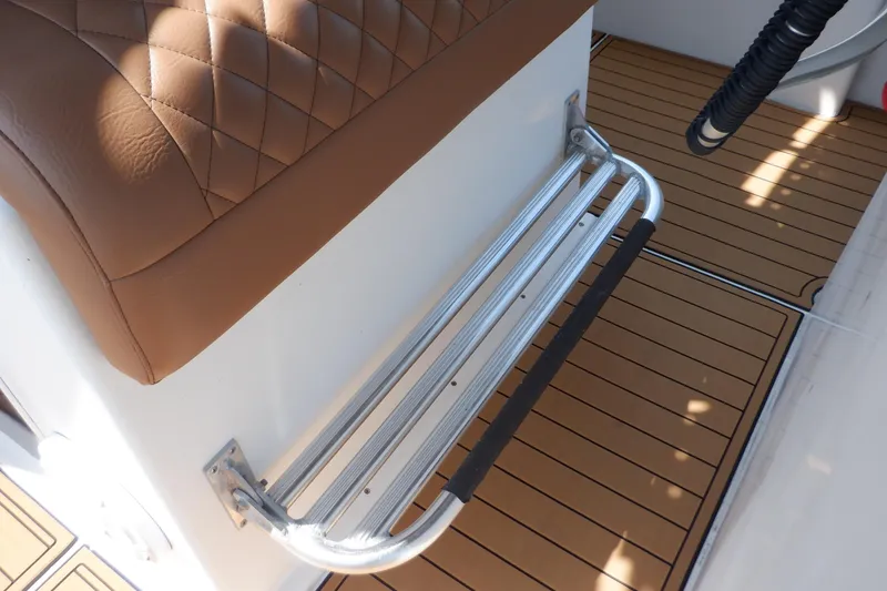Slide: The Image of Brown leather seat and metal footrest on 1995 Ocean Master 31 Center Console boat. - 34