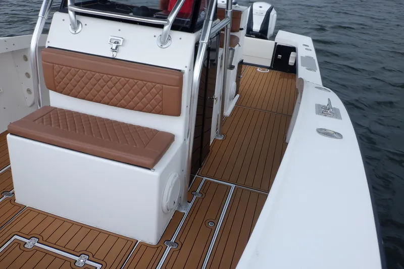 Slide: The Image of 1995 Ocean Master 31 Center Console boat with teak deck and cushioned seating. - 43