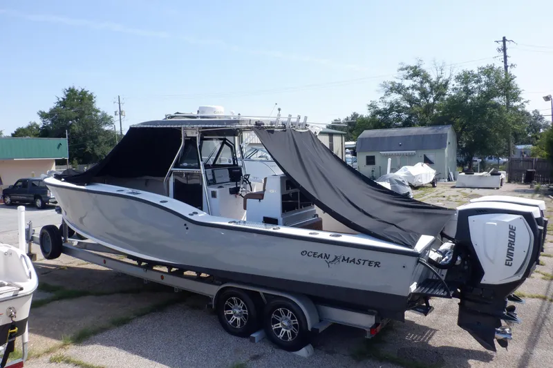 Slide: The Image of 1995 Ocean Master 31 Center Console boat on trailer with Evinrude outboard motor. - 51