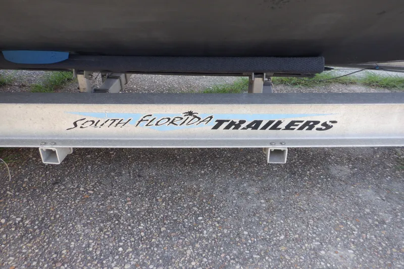 Slide: The Image of Trailer with "South Florida Trailers" logo, supporting a 1995 Ocean Master 31 Center Console boat. - 56