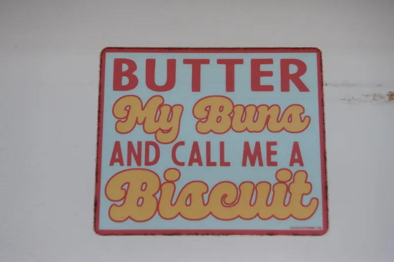 Slide: The Image of "Butter My Buns and Call Me a Biscuit" humorous sign on Ocean Master boat. - 58