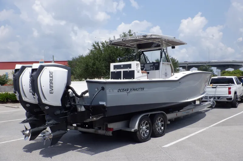Slide: The Image of 1995 Ocean Master 31 Center Console boat on trailer with twin Evinrude engines. - 6