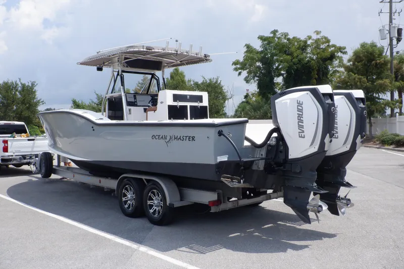 Slide: The Image of 1995 Ocean Master 31 Center Console boat on trailer with dual Evinrude engines. - 8