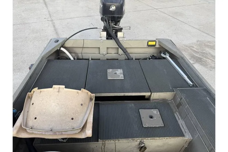 Slide: The Image of 2012 Gator Trax 17X54 boat interior with motor and storage compartments. - 12