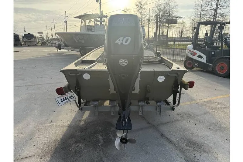 Slide: The Image of 2012 Gator Trax 17X54 boat with 40 HP outboard motor, parked outdoors. - 5