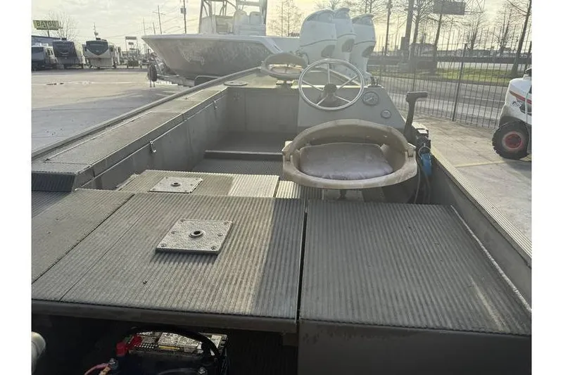 Slide: The Image of 2012 Gator Trax 17X54 boat interior with steering wheel and seating. - 8