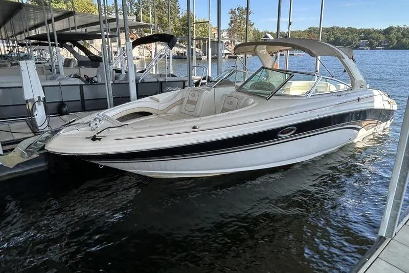 The Image of 2002 Sea Ray 290 Bowrider docked at a marina, featuring sleek design and spacious seating. - 2