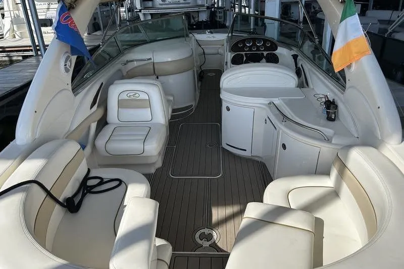 Slide: The Image of 2002 Sea Ray 290 Bowrider interior with plush seating and elegant dashboard. - 3