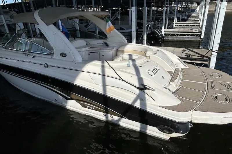 Slide: The Image of 2002 Sea Ray 290 Bowrider docked, featuring sleek design and spacious seating. - 7