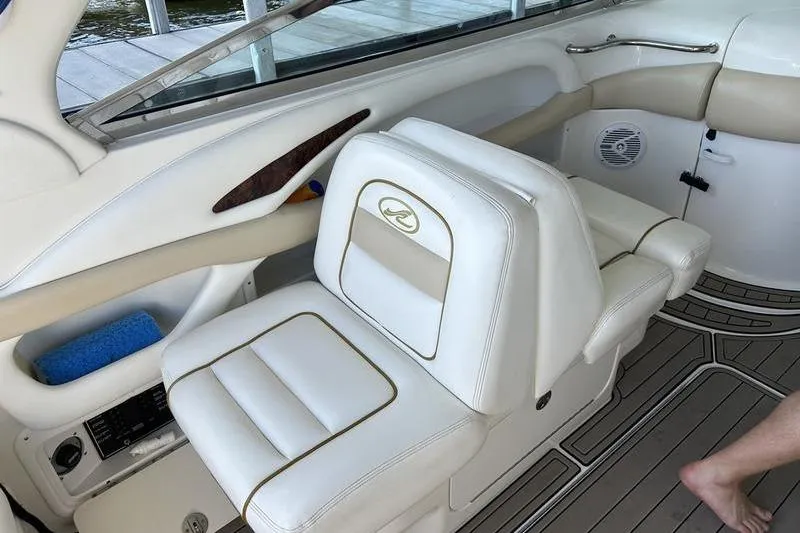 Slide: The Image of 2002 Sea Ray 290 Bowrider interior with white leather seating and modern design. - 9