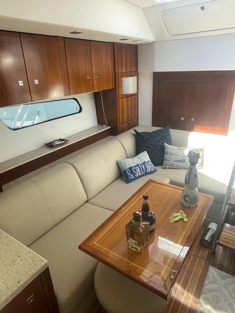Slide: The Image of Luxurious interior of 2012 Cruisers Yachts 48 Cantius with elegant seating and wooden cabinetry. - 12