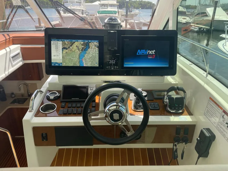 Slide: The Image of Helm of 2012 Cruisers Yachts 48 Cantius with navigation screens and controls. - 8