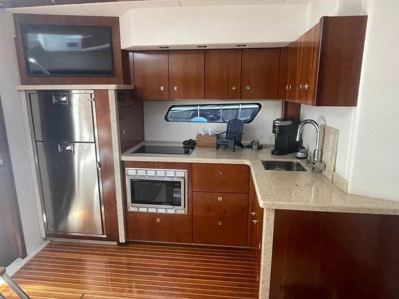 Slide: The Image of Luxurious 2012 Cruisers Yachts 48 Cantius kitchen with modern appliances and wood cabinetry. - 13
