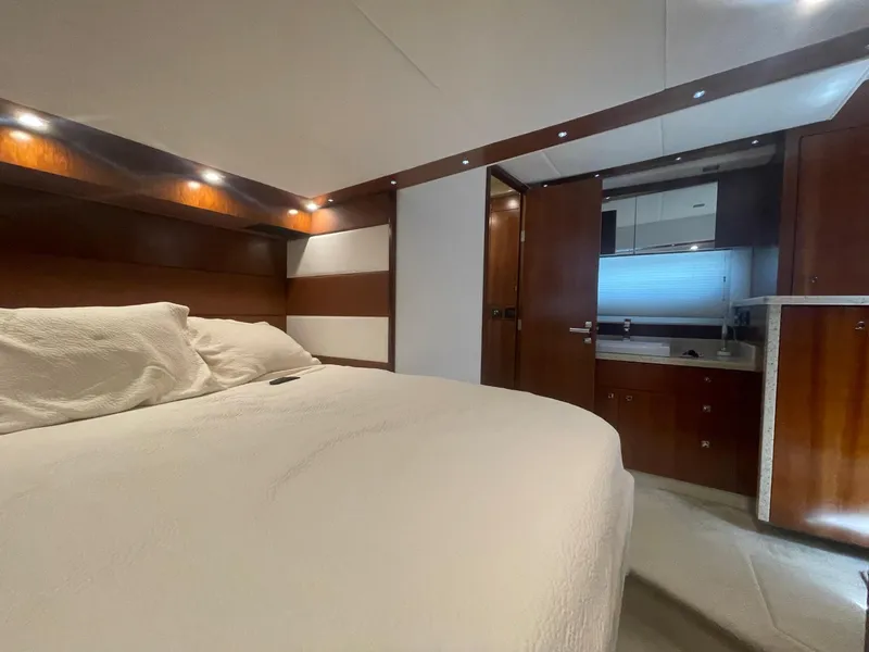 Slide: The Image of Luxurious bedroom interior of 2012 Cruisers Yachts 48 Cantius with wood accents and cozy bedding. - 23