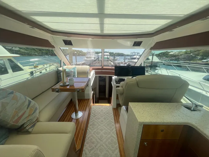 Slide: The Image of Luxurious interior of 2012 Cruisers Yachts 48 Cantius with plush seating and helm. - 4
