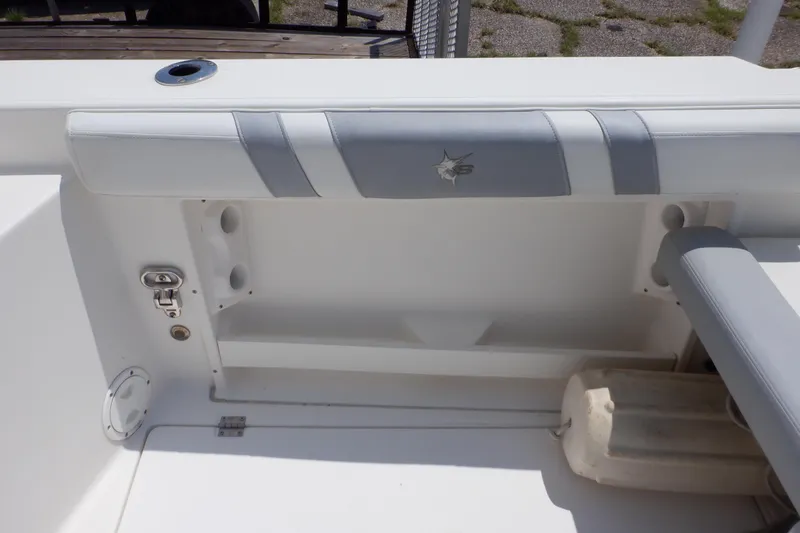 Slide: The Image of 2015 Seaswirl Striper 220 Walkaround boat interior with cushioned seating and storage. - 12