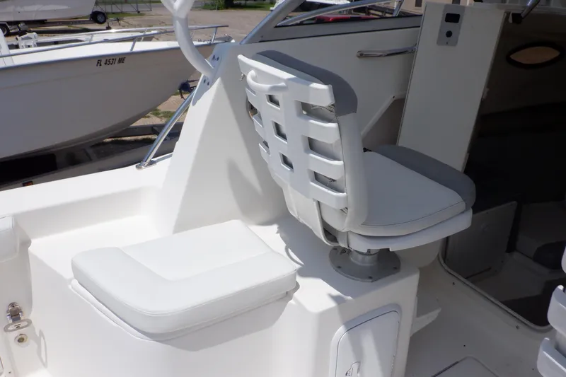 Slide: The Image of 2015 Seaswirl Striper 220 Walkaround boat interior with white seating and helm area. - 24