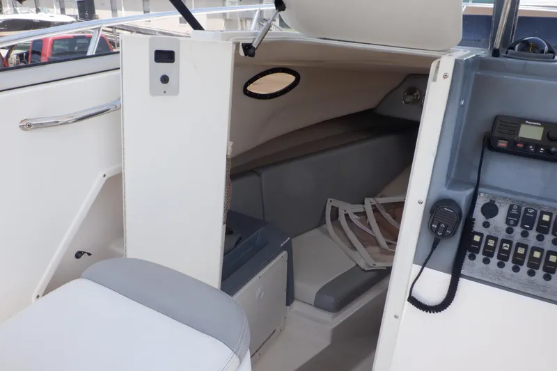 Slide: The Image of 2015 Seaswirl Striper 220 Walkaround cabin interior with seating and control panel. - 25