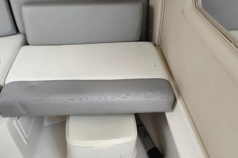 Slide: The Image of 2015 Seaswirl Striper 220 Walkaround boat interior seating with gray and white cushions. - 28