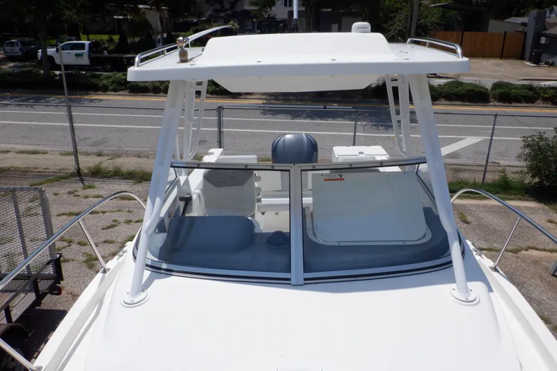 Slide: The Image of 2015 Seaswirl Striper 220 Walkaround boat with hardtop and windshield, parked on land. - 9