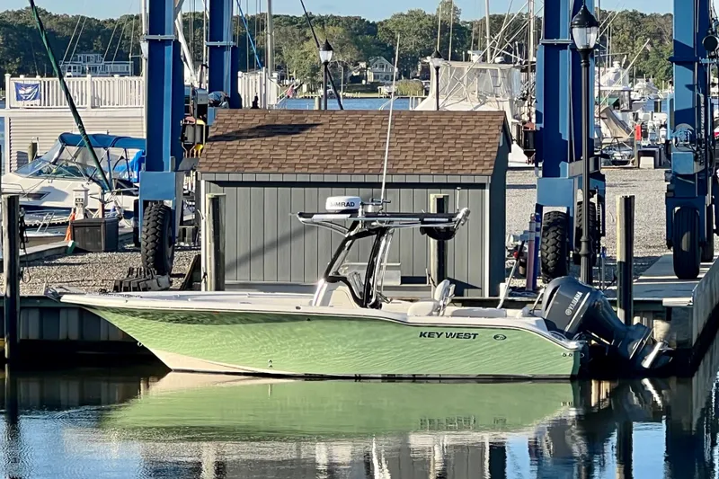 The Image of 2011 Key West 244 Center Console boat docked at marina with Yamaha engine. - 0