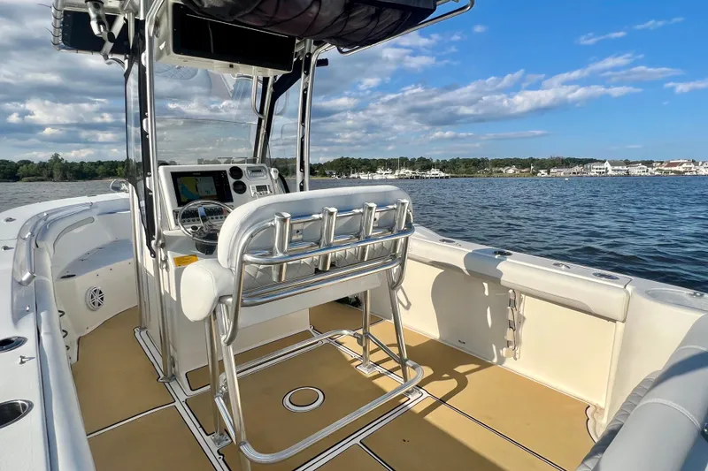 Slide: The Image of 2011 Key West 244 Center Console boat interior on calm water, featuring navigation equipment. - 12