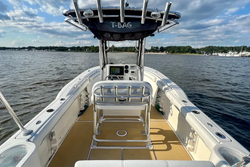 Slide: The Image of 2011 Key West 244 Center Console boat on calm water under a partly cloudy sky. - 13