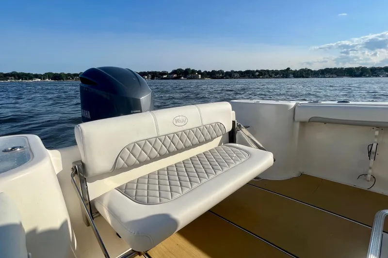 Slide: The Image of 2011 Key West 244 Center Console boat interior with Yamaha engine on a sunny day. - 16