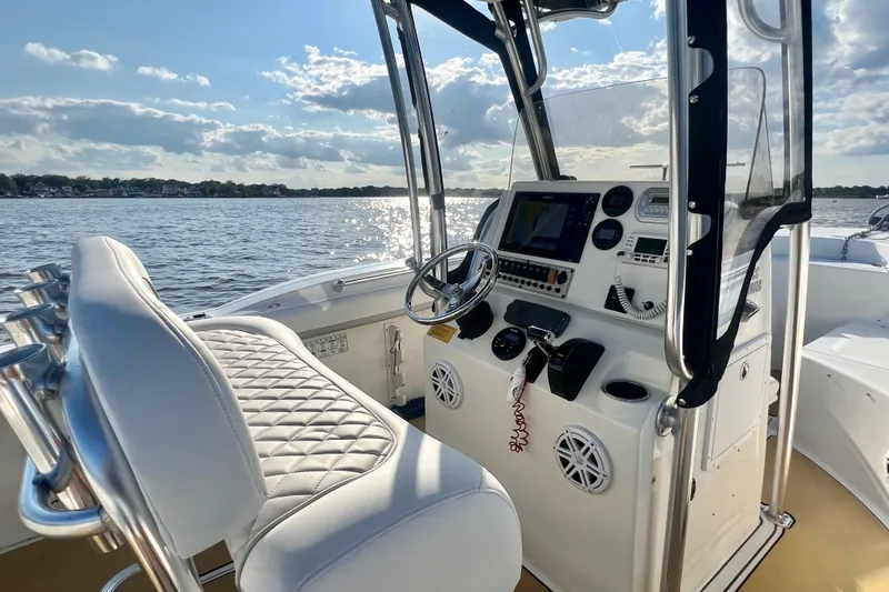 Slide: The Image of 2011 Key West 244 Center Console boat interior with steering wheel and navigation equipment. - 18